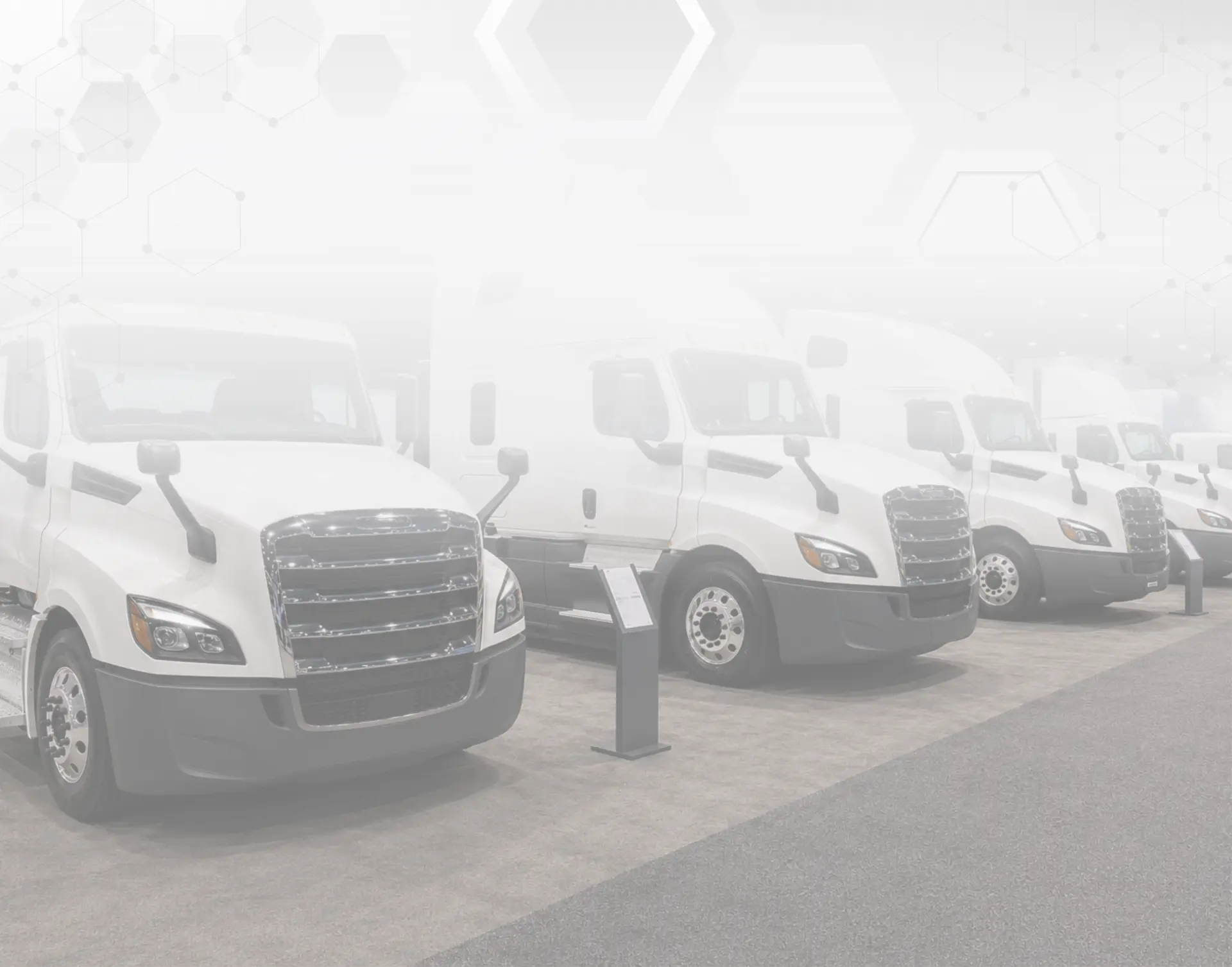 HaldiTech trade-show booth with white trucks and hexagon graphics