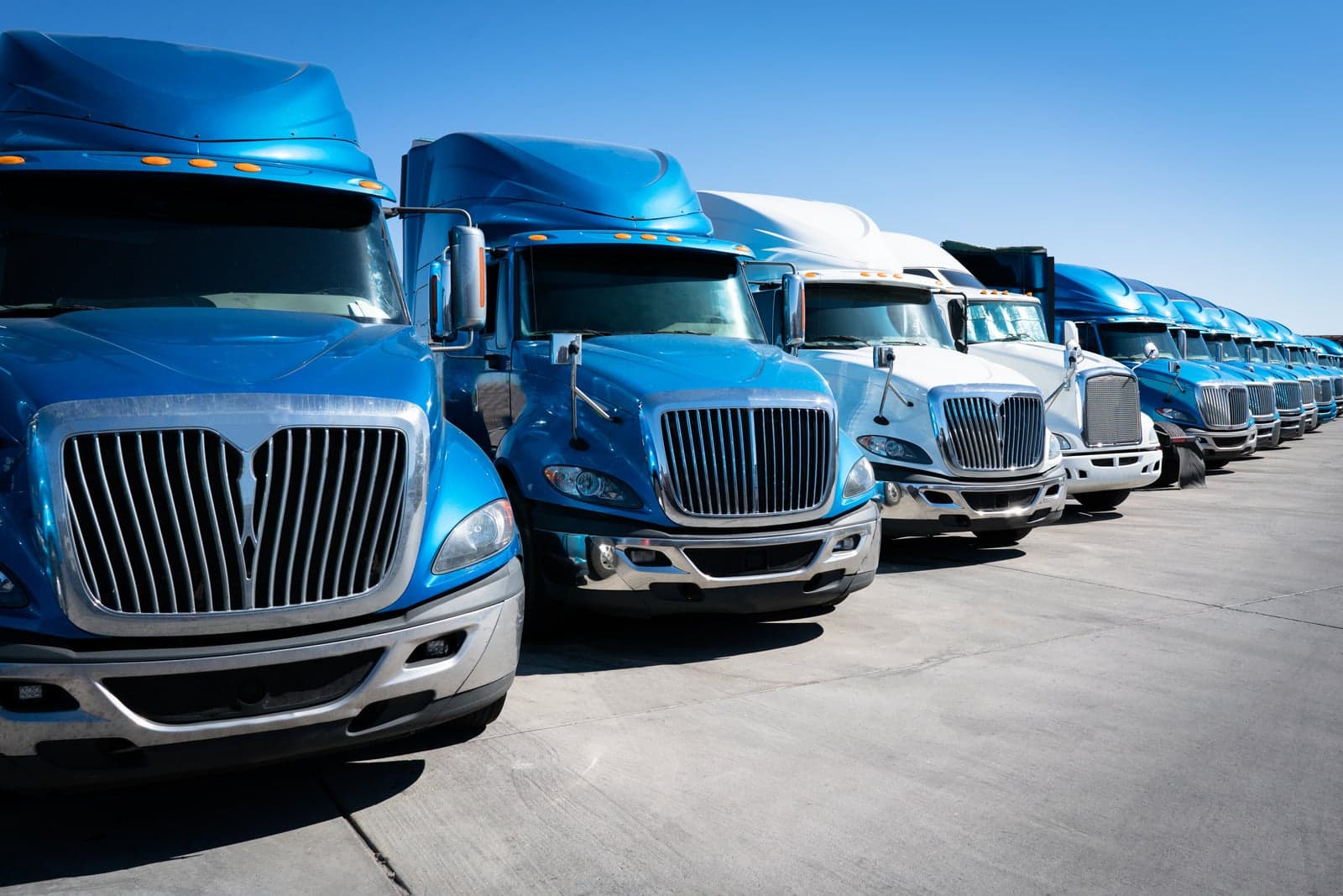 A row of linehaul trucks parked at a terminal